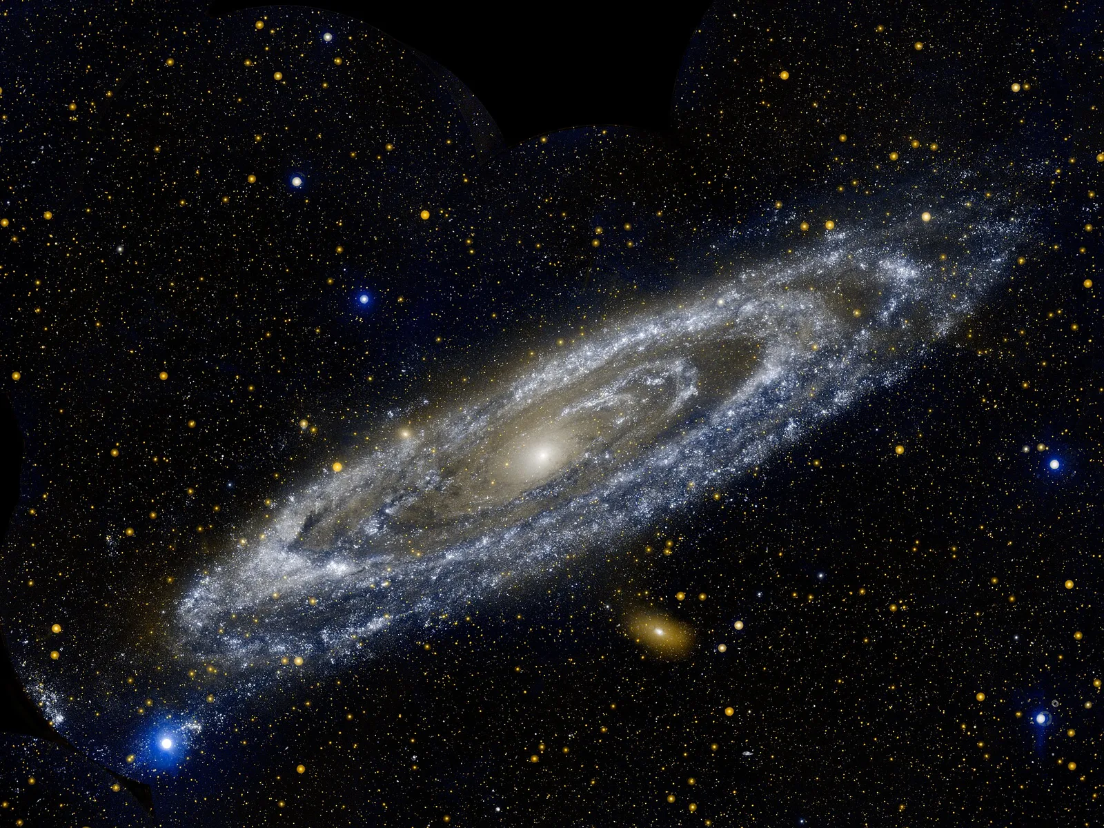 The Andromeda Galaxy in ultraviolet, a tilted spiral of blue-white stars.
