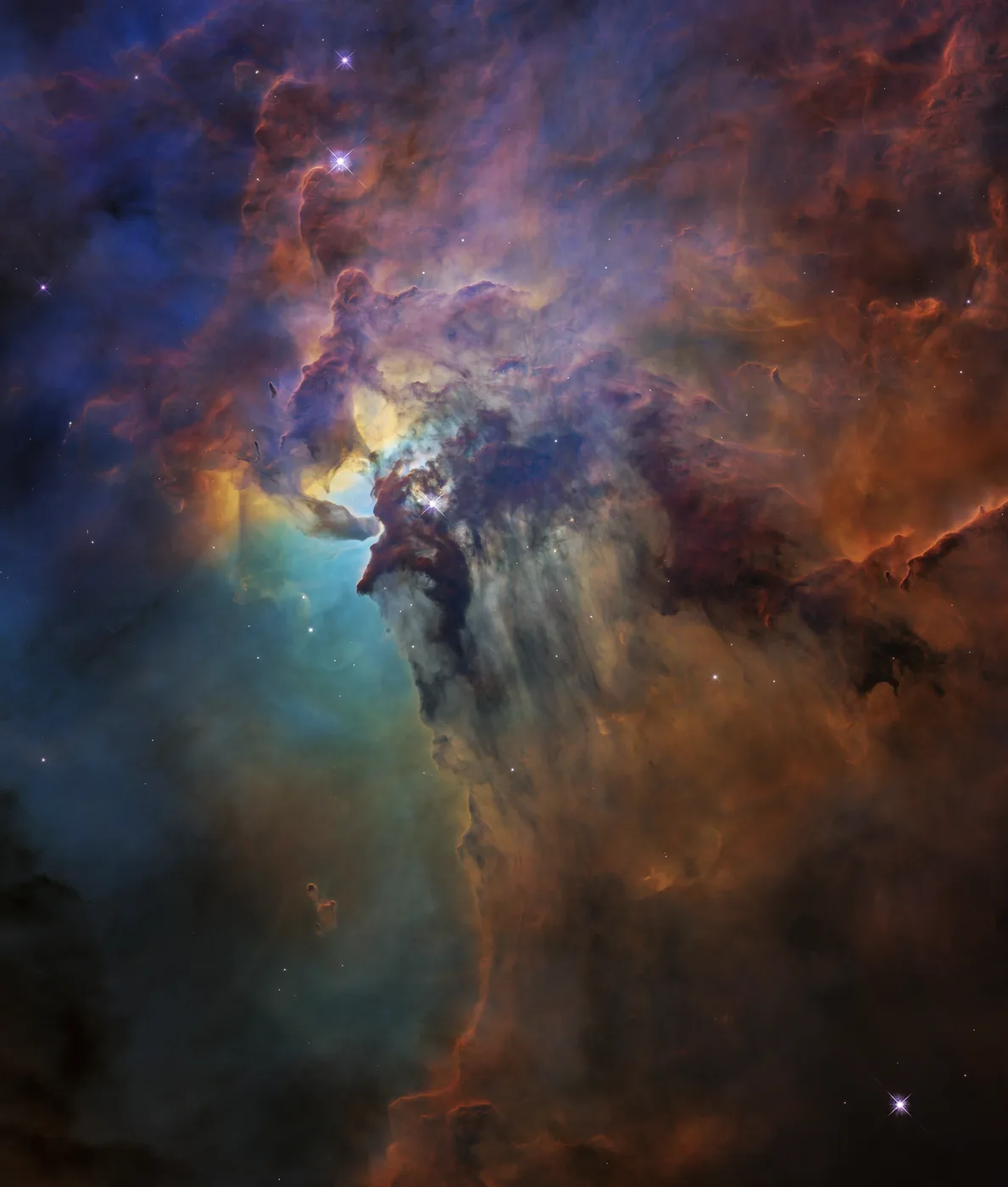 The Lagoon Nebula: billowing orange and blue clouds of gas and dust.