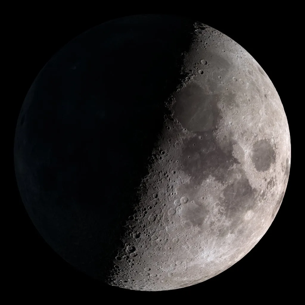 A half-lit Moon, the right half bright, against black space.
