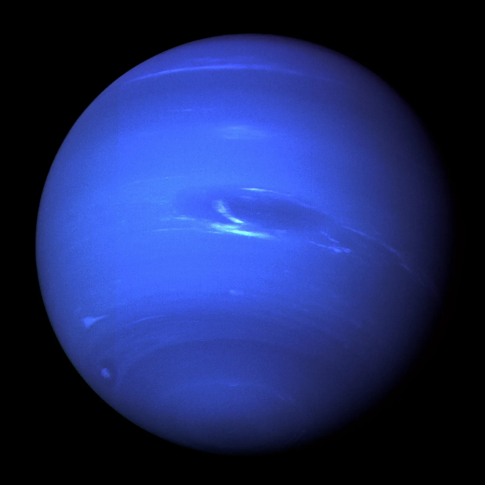 Neptune, a deep blue planet with white streaks of cloud and a dark oval storm.