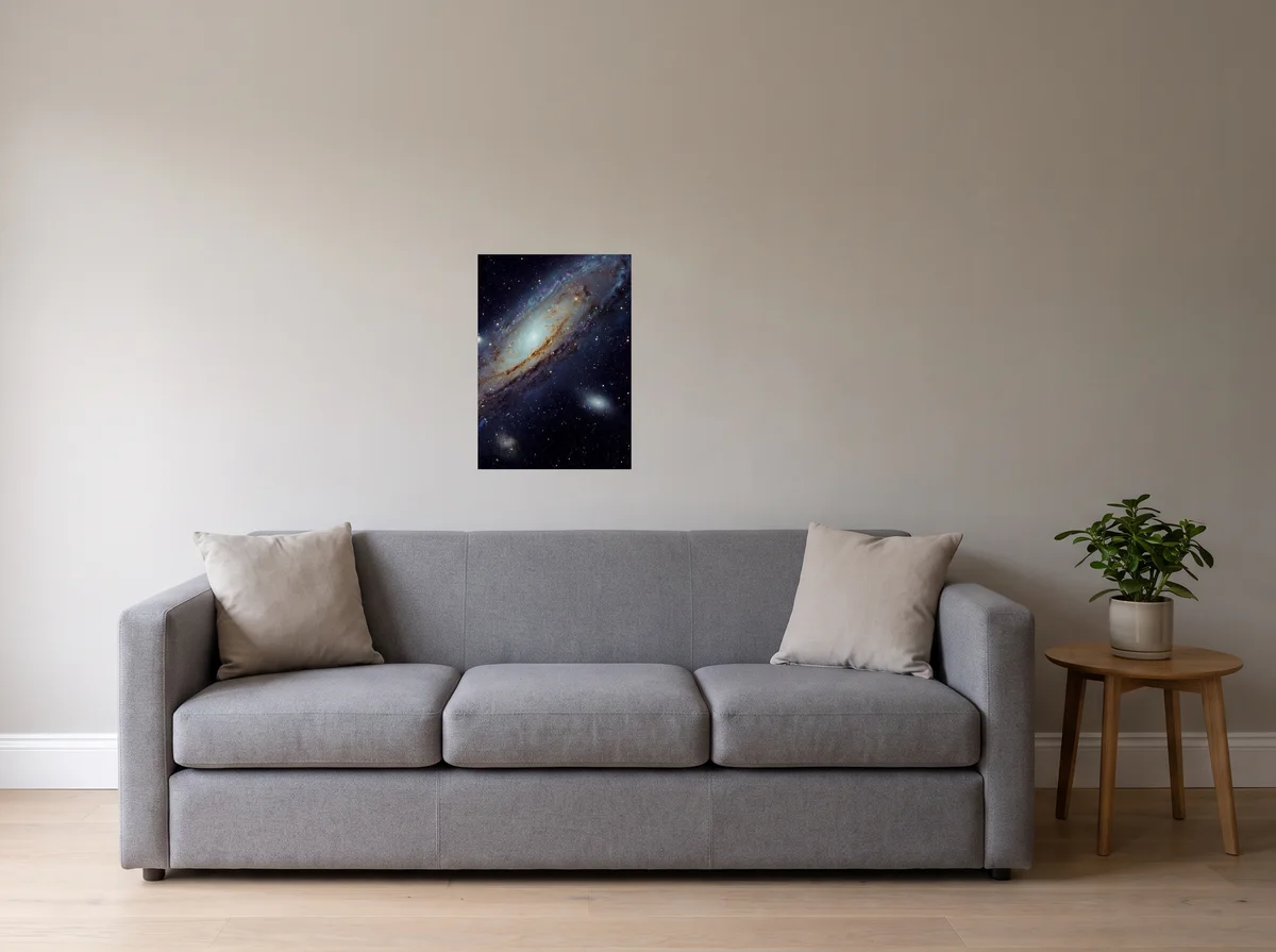Andromeda as a 50x70 cm poster on a light grey wall above a grey sofa