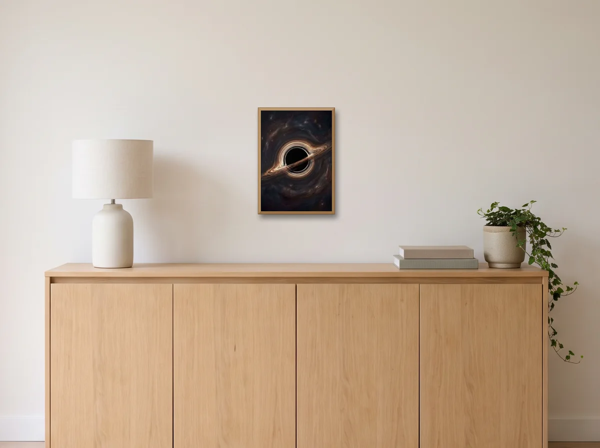 Event Horizon as an A3 poster in a natural wood frame on an off-white wall above an oak sideboard with a lamp and plant