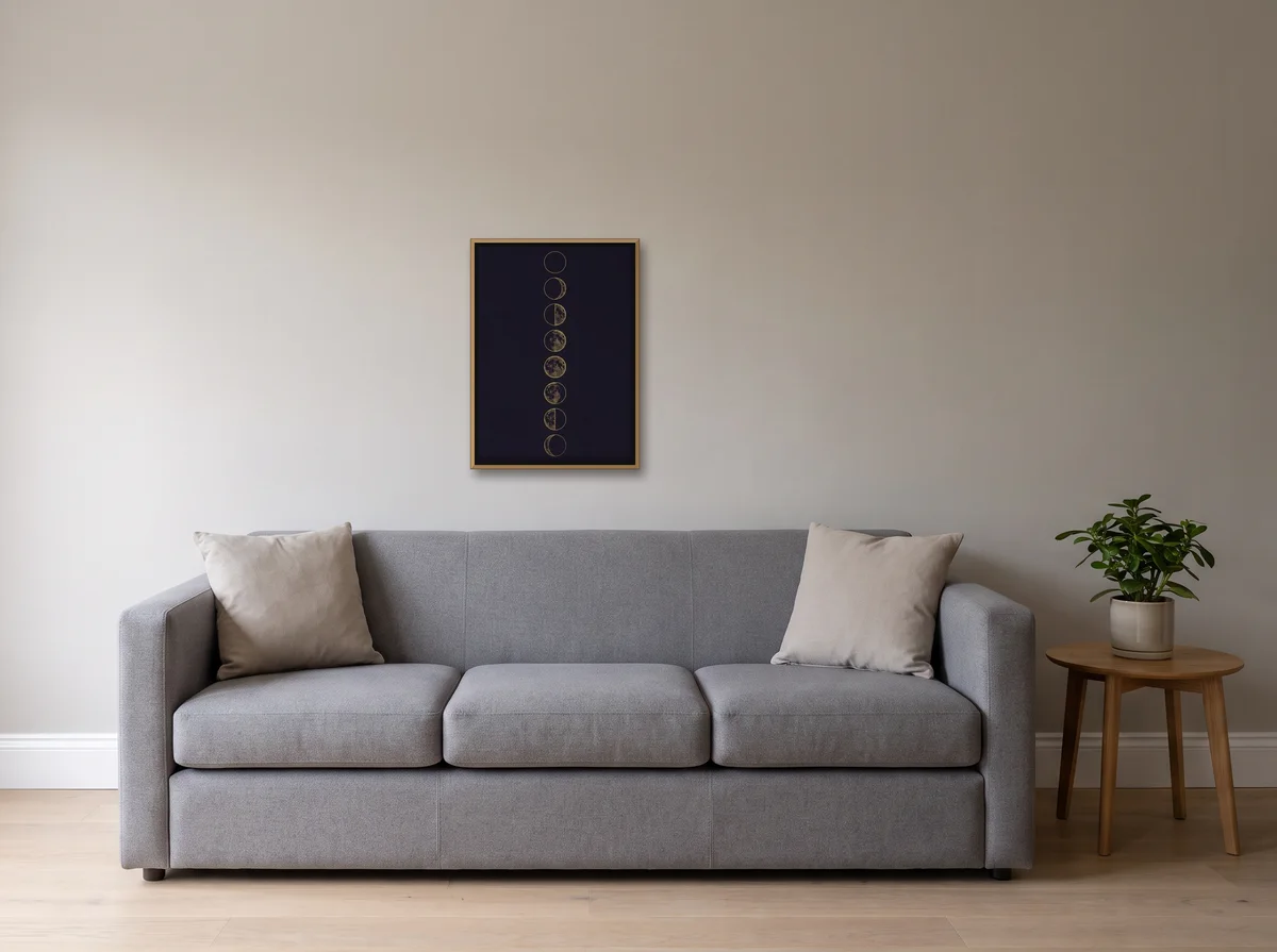 Lunar Phases as a 50x70 cm canvas in a natural wood float frame on a light grey wall above a grey sofa
