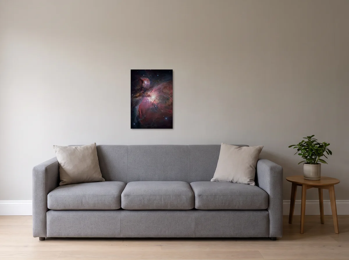 Orion Cradle as a 50 x 70 cm canvas on a light grey wall above a grey three-seat sofa.