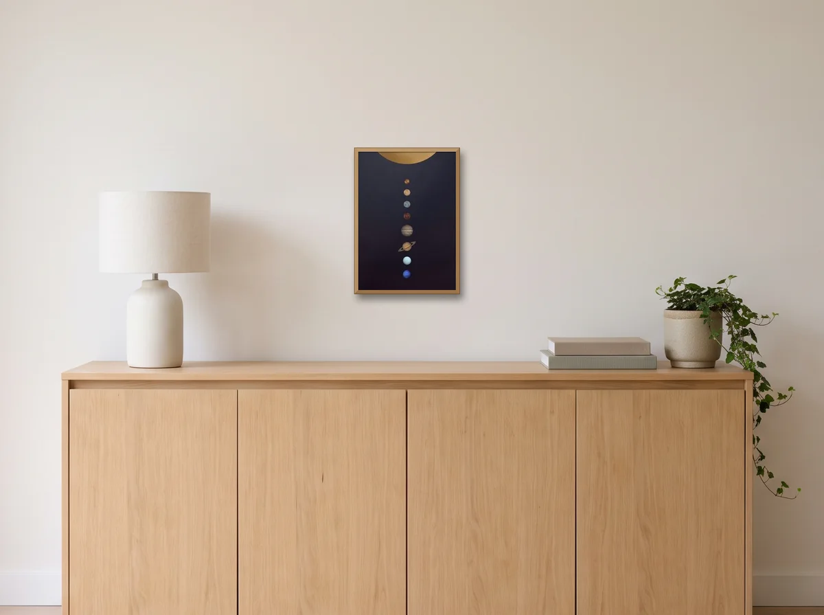 The Solar System, Minimal as an A3 poster in a natural wood frame on an off-white wall above an oak sideboard with a lamp and plant