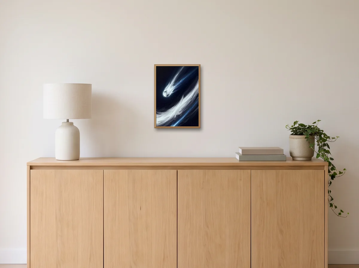 The Long Return as an A3 poster in a natural wood frame on an off-white wall above an oak sideboard with a lamp and plant