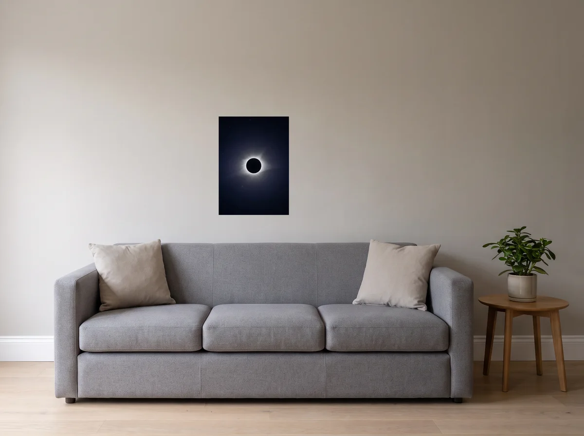 Totality as a 50x70 cm poster on a light grey wall above a grey sofa