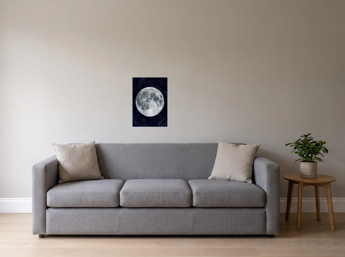 Watercolour Moon as an A2 poster on a light grey wall above a grey sofa